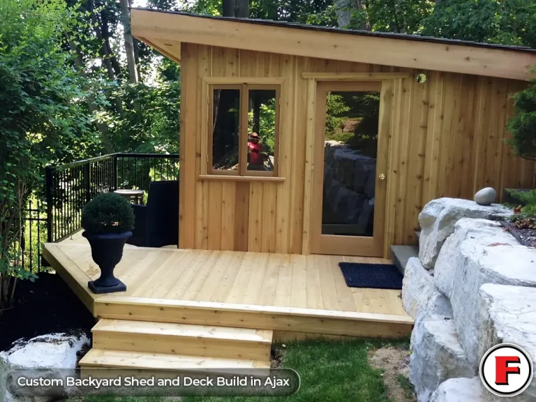 Custom wood backyard shed featuring cedar siding, a slanted roof, and a glass door, built directly onto a new pressure-treated wood deck in Ajax, Ontario.
