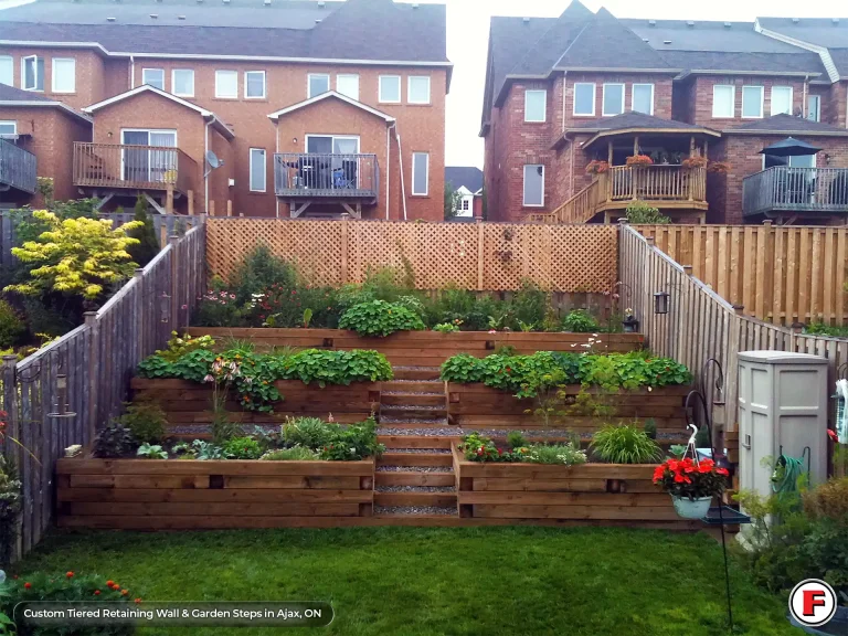 Custom tiered retaining wall system built with pressure-treated wood and integrated garden steps to stop soil erosion in Ajax, Ontario